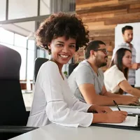 young-african-woman-sitting-at-a-business-presenta-PAY6YEC.jpg